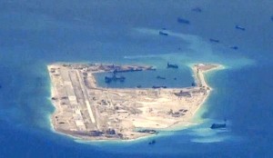 Chinese dredging vessels are purportedly seen in the waters around Fiery Cross Reef in the disputed Spratly Islands in this still image from video taken by a P-8A Poseidon surveillance aircraft provided by the United States Navy on May 21, 2015.
